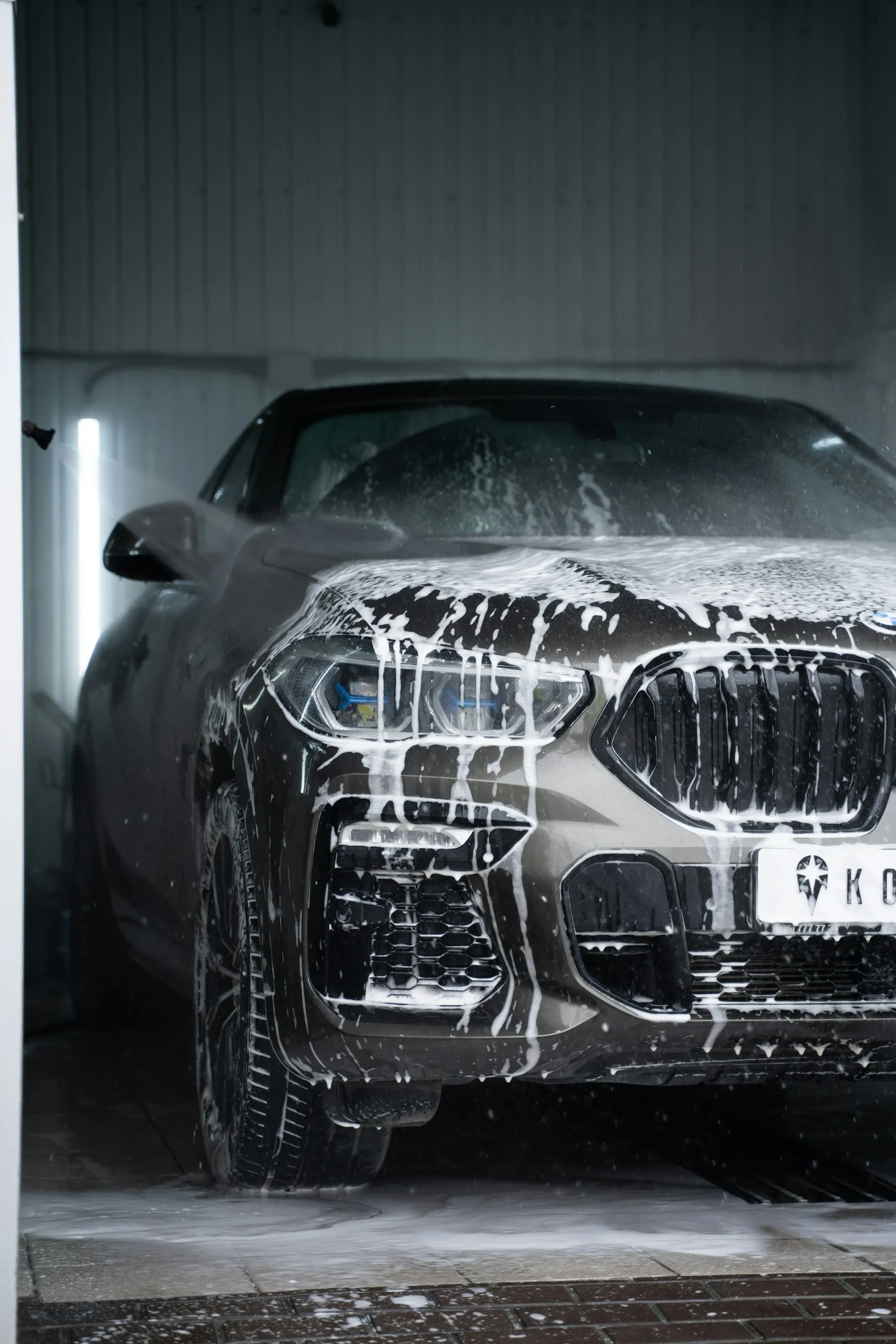 A car covered in foam during a pre wash
