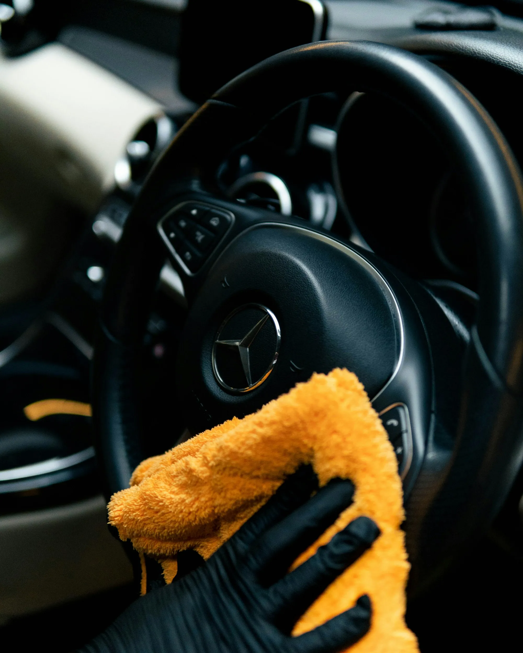 Microfiber towel wiping a steering wheel